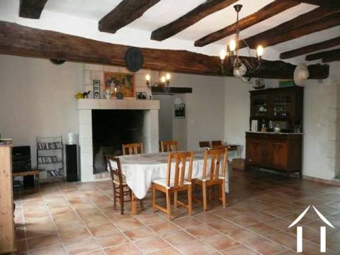 The dining room is probably the centrepiece of the property and certainly one of the main entrances opens into this room. At 35m2+ this is an impressive room with high ceilings, exposed oak beams, stone walls and a working fireplace. The kitchen is accessed from this room. 