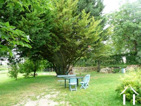 The garden is mature, quiet and on two sides joins land owned by the Mairie (which is located beyond the hedge).
