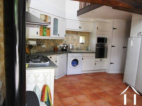 The kitchen is not a traditional rectagular shape and has a staircase with small mezzanine that leads to the main bedroom. Off the kitchen is the dining room.    