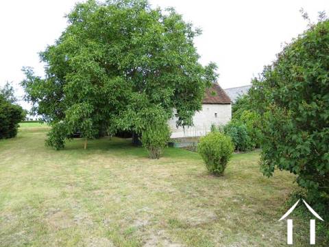 The property has a mature garden which opens out onto fields and orchards. 