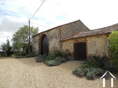 The outbuildings, facing the house and forming part of a sheltered courtyard. 