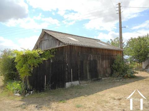 The wooden barn with stable attached is deceptively large and includes two existing stalls. This building is in good condition. 