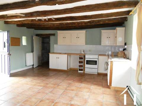 The kitchen sits at the centre of the house with the bathroom off at one end and the lounge to the other. It is a classic country-style room with windows on both the front (overlooking the courtyard) and to the back wall (overlooking countryside and the approach to the property). This room has lots of features including an old stone fireplace and exposed oak beams. 