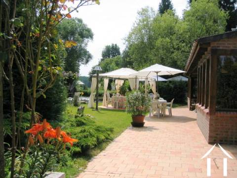 There is a large dining / sun and drinks terrace to the front of the property, overlooking the two small lakes. 