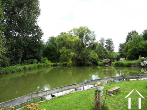 This is the view from the terrace. The lake is fed by a naural water source that rises behind the property and forms a small mill race that used to turn the wheel (no longer in position).    