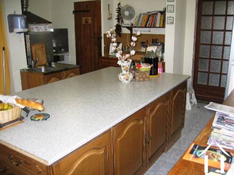 The fitted kitrchen, equipped with professional grade cooking, washing-up and laundry facilities. The door (back left of picture) leads to the cave.    