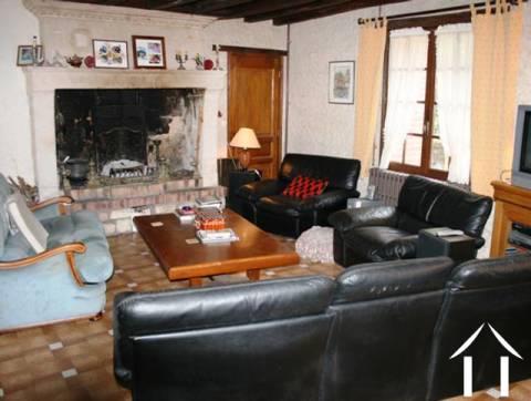 The owners lounge/dining room with exposed oak beams and a feature fireplace. 