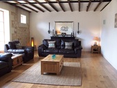 The lounge with its feature stone walls and hardwood flooring.