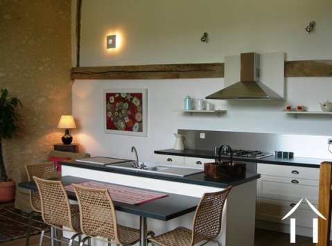 The kitchen in the gîte is both modern and American-style and faces into the lounge area.