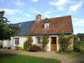 The gîte (maison d'amis) with a terra cotta tile roof. Like the house, it is built of tuffeau limestone and maintains many of the features characteristic of properties built in the Loire during the late 19th century.