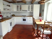 By contrast with the gîte, the house has a separate kitchen which has a distinct country style although this is a modern and recent installation. Also of note is the high quality terra cotta tile floor.