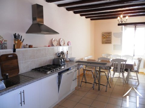 The kitchen has been upgraded to a high standard whilst still retaining some of its original character with exposed oak beams and exposed tuffeau limestone around the windows. There is lots of light this room with windows to the front and the back.