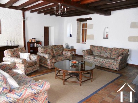 The lounge is fairly dramatic because of its size and height with exposed oak beams, a fireplace and exposed stone around the windows.