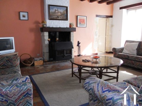 The lounge with its fireplace and wood burning stove (a 'Villager') which is included in the sale of the property (as are all the stoves).