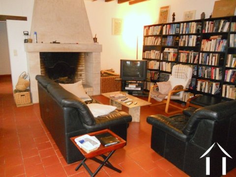 The lounge has a terra cotta tiled floor, a large working fireplace and like all the rooms in this property, it has impressive views over the surrounding countryside.