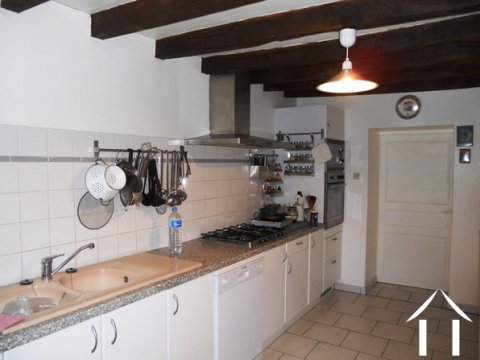 The kitchen (approx 20m2) with a large cellar (arrière cuisine) beyond.