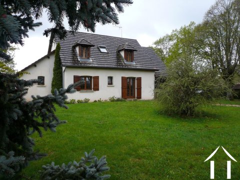 house within park on edge of small village