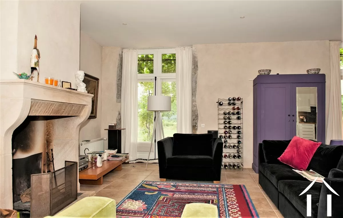 sitting room with stone fireplace