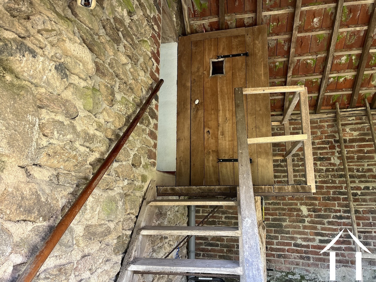 stairs up to bedroom in second house, with toilet