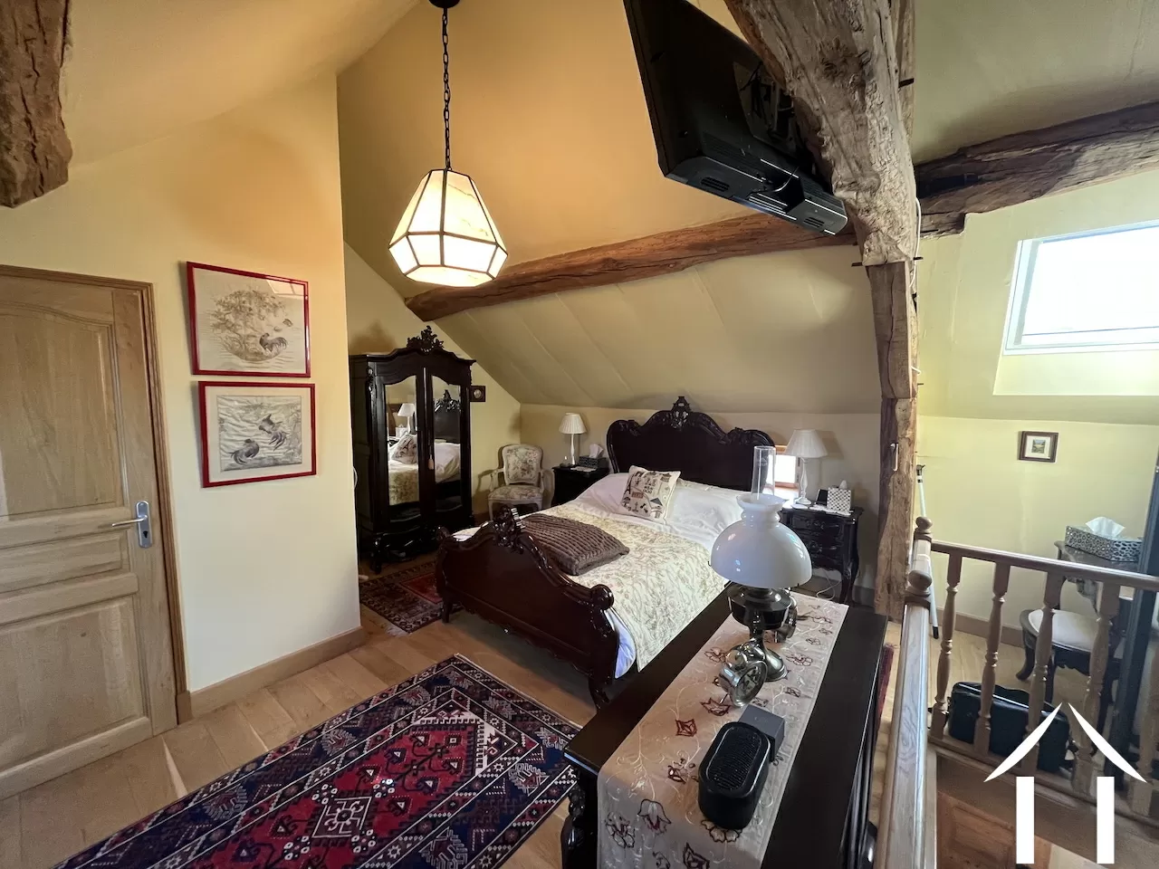 bedroom in open space of first floor, with en suite shower room next to it.