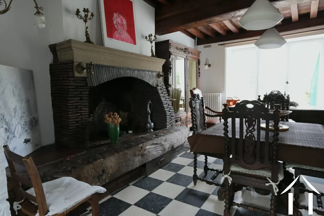 House 1: Living room with fireplace and large French doors