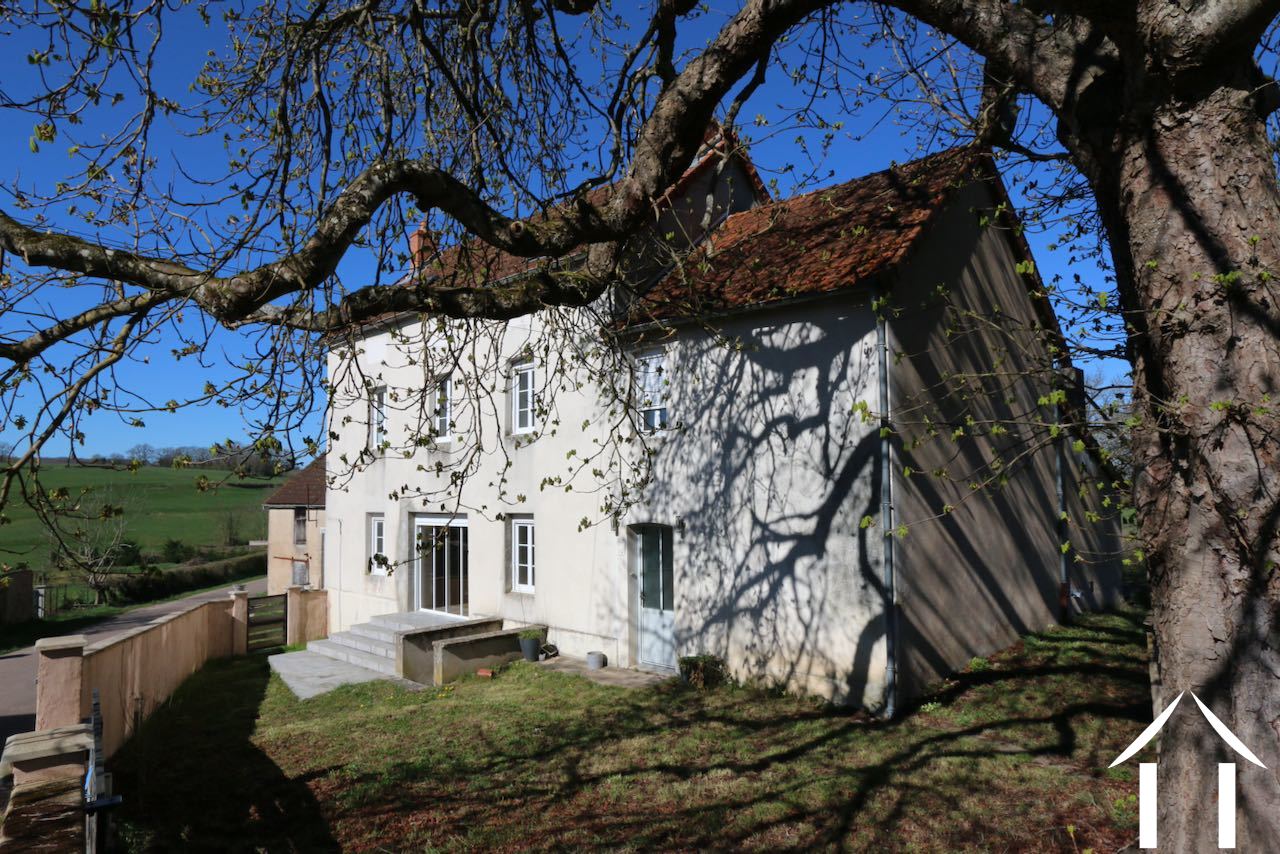 Tall house with barns and garden