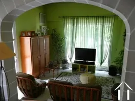 The TV viewing area (sejour) with picture window that looks over the courtyard and the garden beyond.