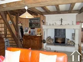 This shows part of the living room with its stone firepace and inset wood burning stove