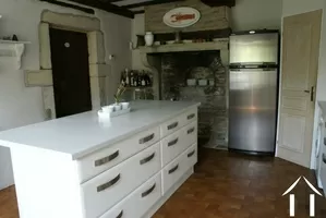 Kitchen with island workbench and fireplace