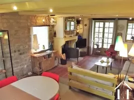 Living area with character fireplace and beams