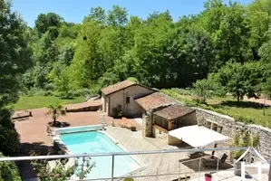 View over the pool and stone outbuildings