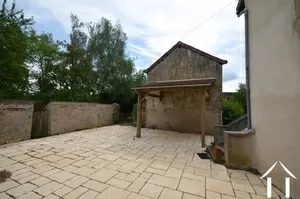 terrace in between house and barn, with covered area