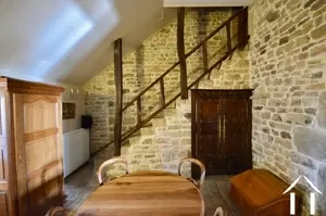quiet room to the back of living room with stone staircase
