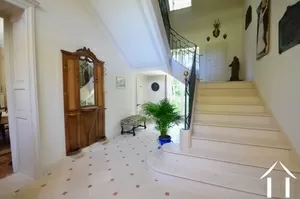 Stone clad hallway and stairs to first floor