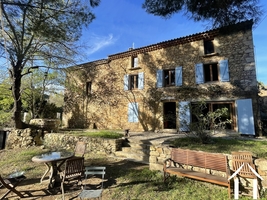 Stone farmhouse in a hilly and Mediterranean landscape