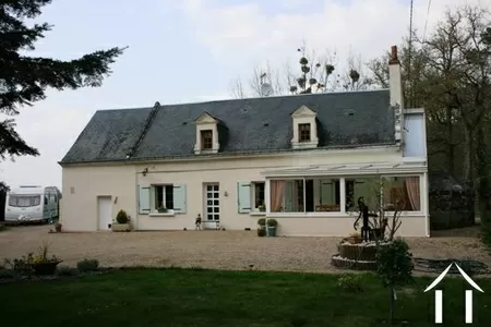 The property is located on a country lane with a number of neighbours (none are too near). This longère is built of tuffeau limestone with a cream enduit (rendering) and an ardoise slate roof. The lucarne windows (dormer windows) are built with dressed tuffeau limestone. 