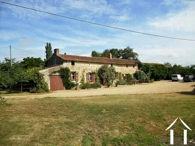 The house is classic of the region to the south of the Loire. Built of a mix of limestone, sandstone and flint, it has a terracotta tile roof. Originally a farmhouse, the property retains a large open grange to one end and sits facing outbuildings that equal the size of the 