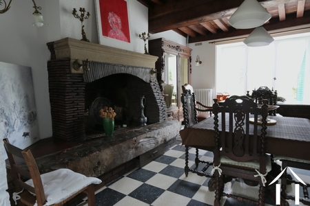 House 1: Living room with fireplace and large French doors