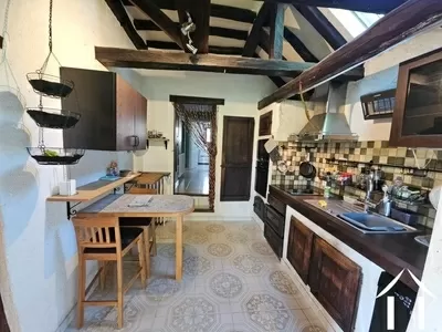 Kitchen featuring exposed beams and access to the conservatory